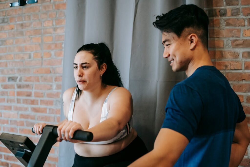 Spin bike vs exercise bike: girl getting trained on spin bike