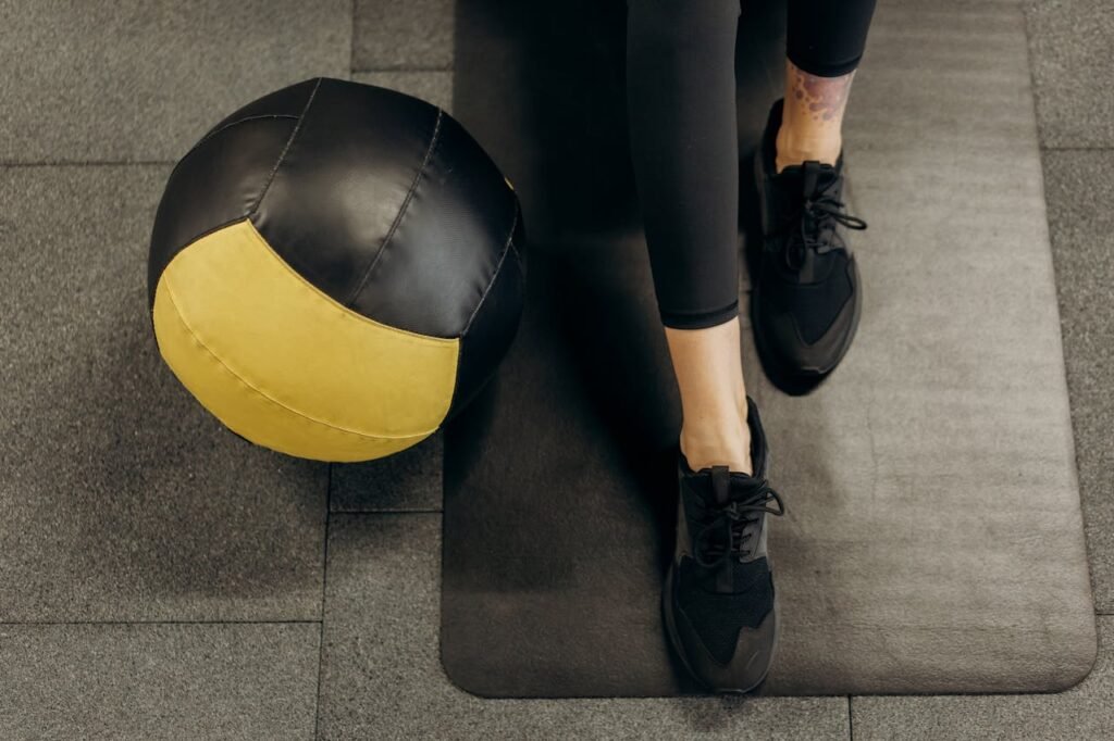 Medicine balls: Medicine ball on floor next to legs