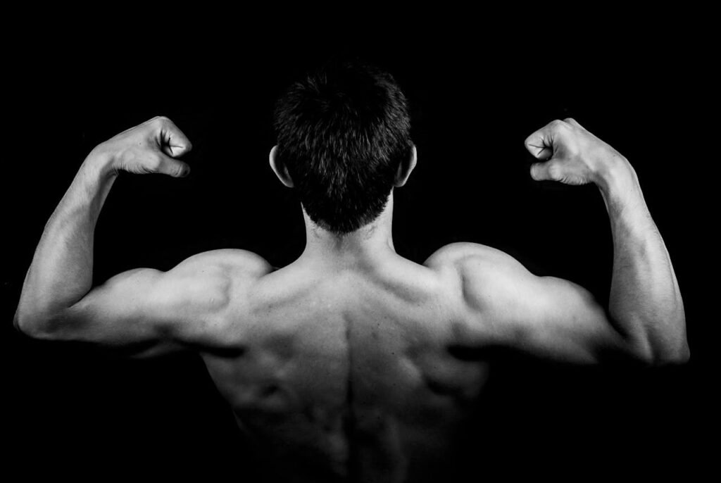 Calisthenics back workouts: man posing back double biceps 