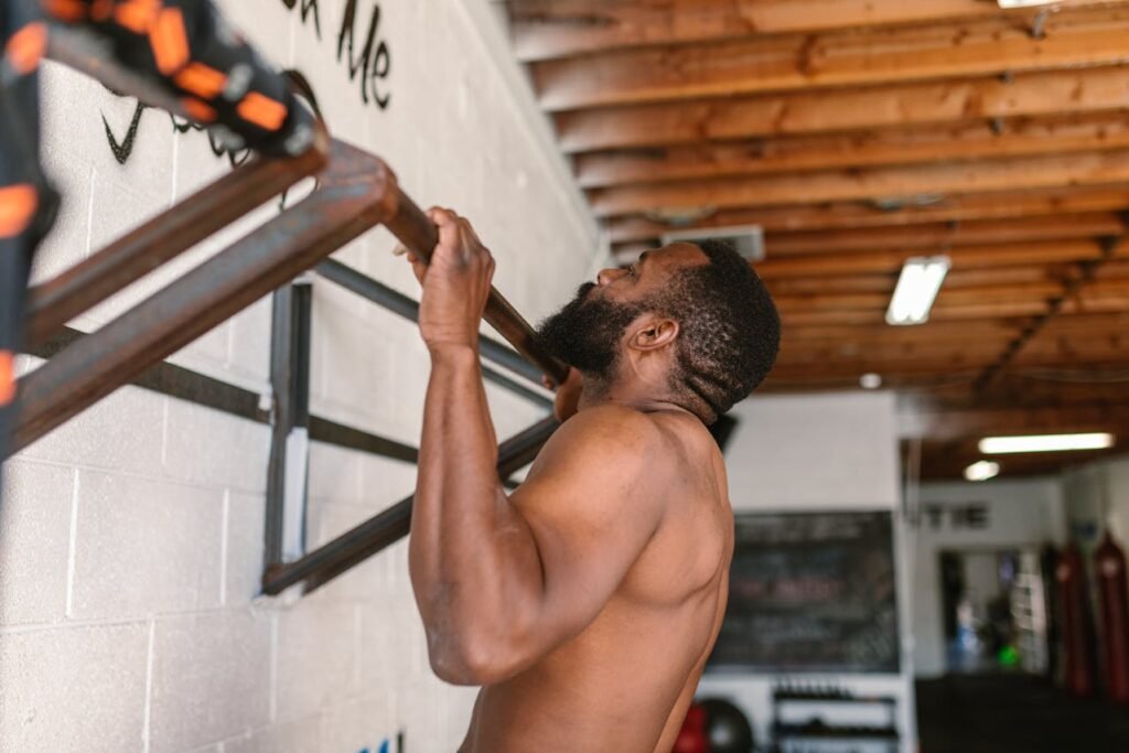 Calisthenics back workouts: man, doing pull ups