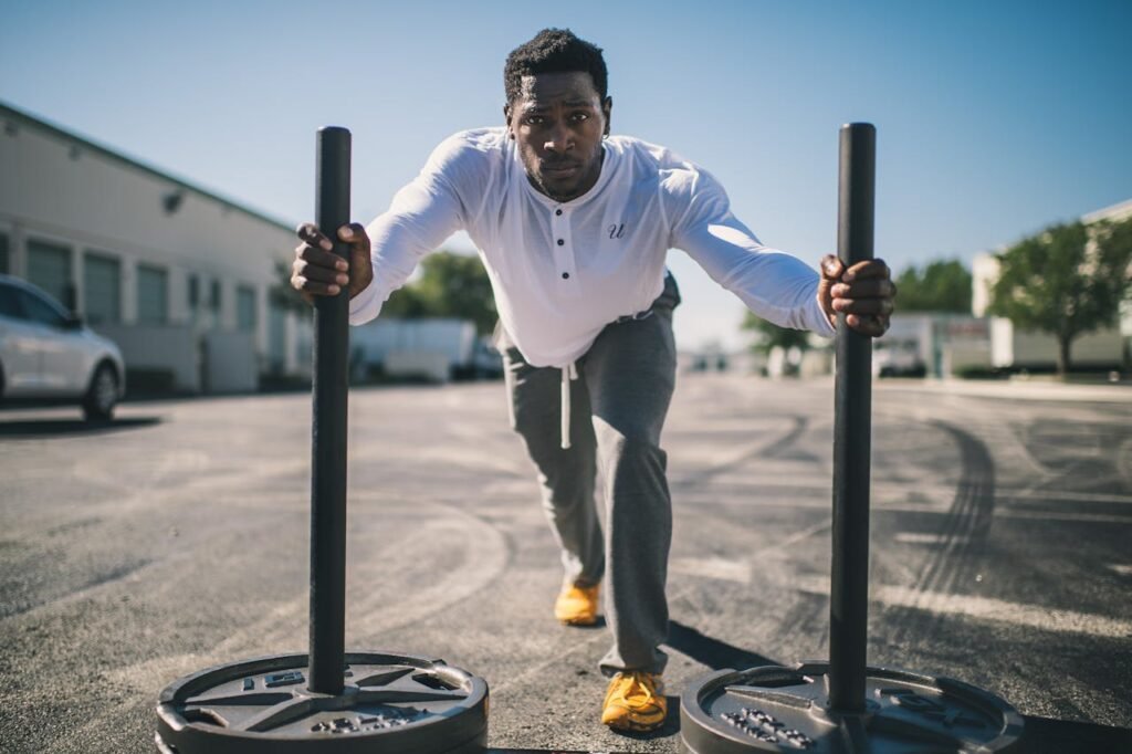 Weighted sleds: man pushing sled