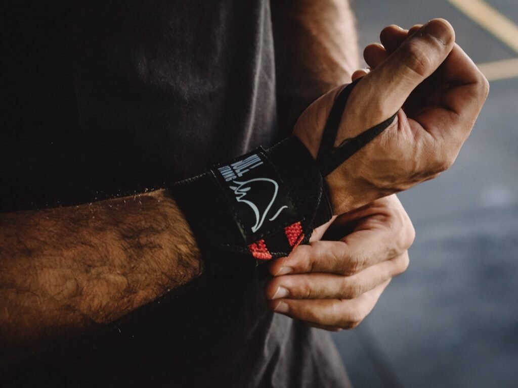 Gym straps: Man Putting on a Wrist Strap